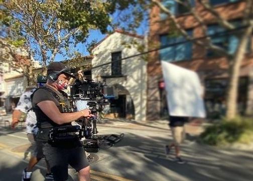 Nick Schwyter operating a stabilized camera on a street production for DoorDash.